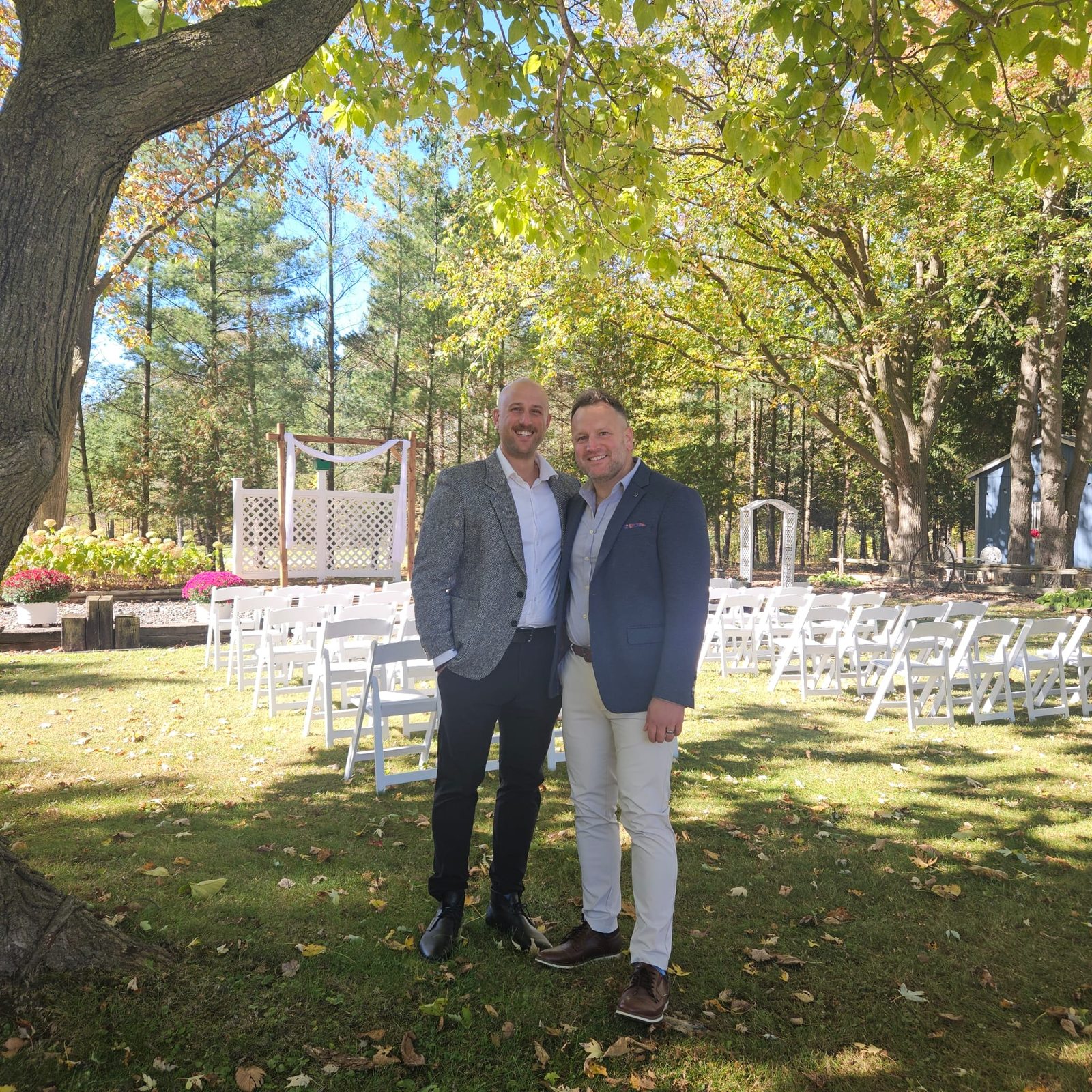 The duo at an outdoor wedding ceremony site